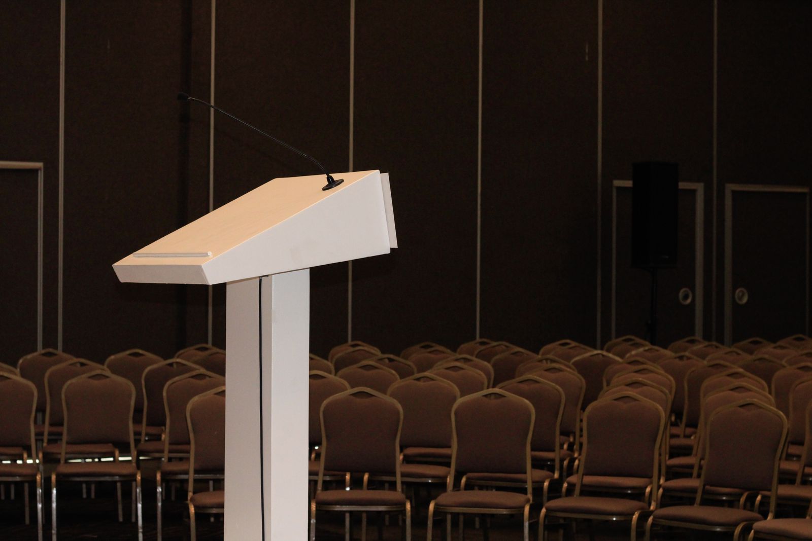 Unbranded conference podium and seating prepared for a presentation